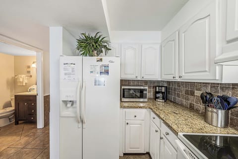 The fully equipped kitchen features granite countertops and has everything you need to prepare meals for family & friends.