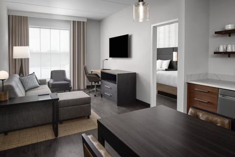 Unwind in the bright suite with lounge seating and TV.