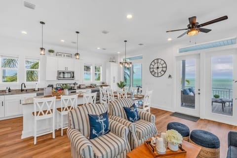 Wide Open Space | Kitchen + Living Room + Water Views Cook, relax, and dine together in this elegant coastal retreat designed for connection and comfo