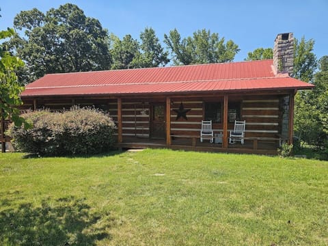 Quaint cabin on beautifully landscaped grounds.