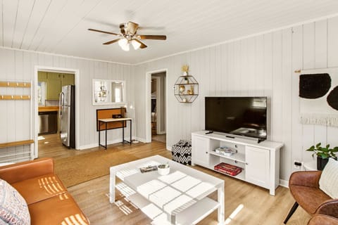 Cozy living room with modern decor and ample natural light, perfect for relaxation and entertainment.