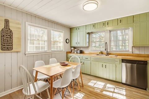 Charming kitchen with vintage cabinets and ample natural light, perfect for cozy meals.
