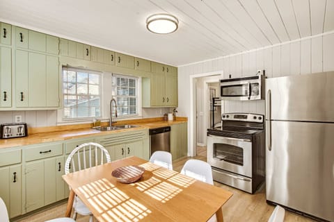 Charming kitchen with modern appliances and cozy dining area, perfect for family meals.
