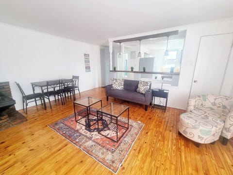 The living room comes furnished with essential pieces, including a comfortable sofa, a coffee table, TV stand, and dining table, providing immediate comfort upon move-in.
