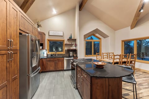 Full kitchen featuring all stainless steel appliances, air fryer, and five-burner stovetop.