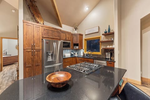Full kitchen featuring all stainless steel appliances, air fryer, and five-burner stovetop.