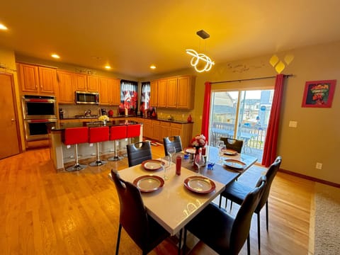 Vast kitchen and dining space overlooking a charming patio, offering a delightful atmosphere for dining and unwinding