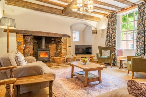 The Old Gatehouse, Walsingham: Sitting room with wood burning stove