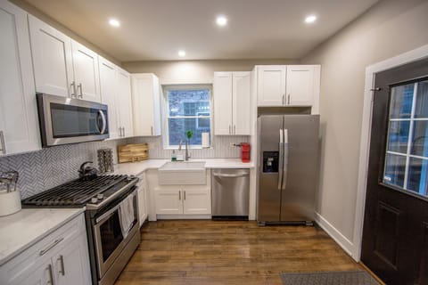 Fully equipped kitchen with refrigerator, dishwasher, microwave, and oven 