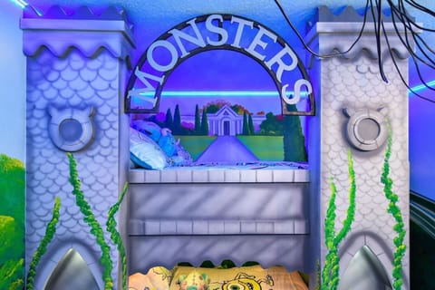 This room brings the Monsters, Inc. world to life with two full beds and access to a shared hallway bathroom (with a shower), shared with the Harry Potter Room. Also includes a smart TV.