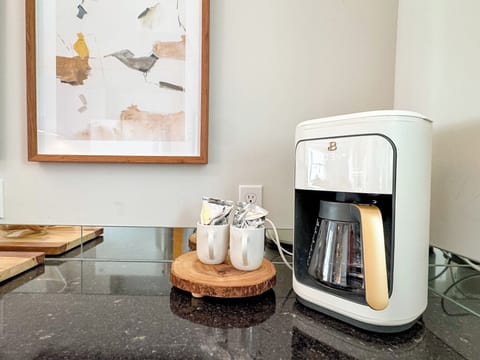 New digital coffee maker and two starter packages of coffee provided. 