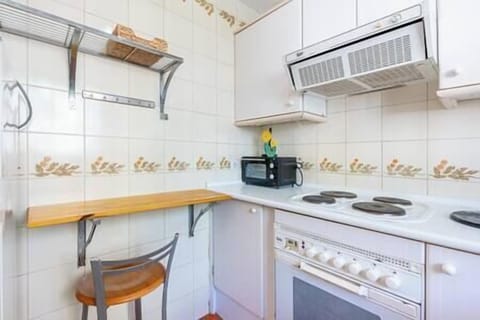 Kitchen equipped with refrigerator, microwave, oven and washing machine. Tableware and utensils for (2)