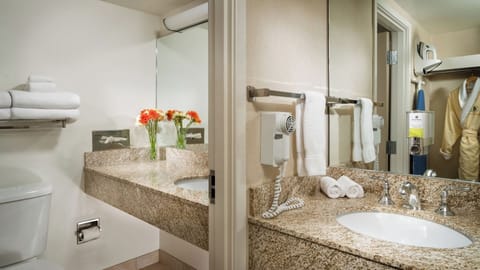 Refresh at a bright granite vanity with fluffy towels.