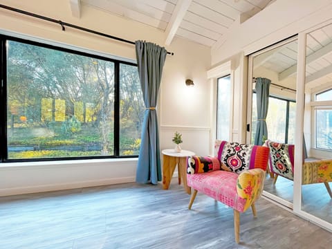 Peaceful nook for coffee or a book, surrounded by trees and sunlight.