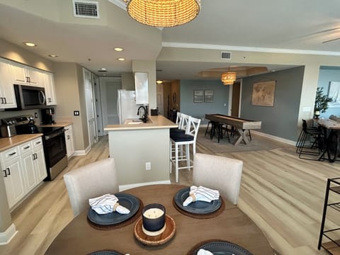 Dining table with additional bar stools seats. Shuffleboard also has top. 