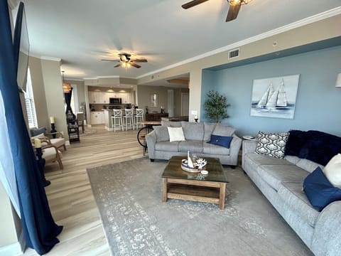 Living room with 2 full couches and additional seating near. 