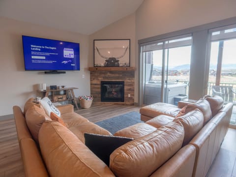 A bright, open living room with stunning views of the golf course and surrounding mountains.