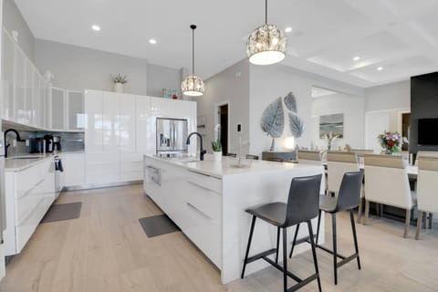 The kitchen features quartz counters, dual sinks, smooth cooktop, Viking stove, microwave, warming drawer, refrigerator/freezer and dishwasher.