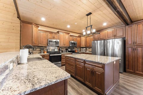 Plenty of space for cooking in this large kitchen featuring two ovens and large fridge/freezer