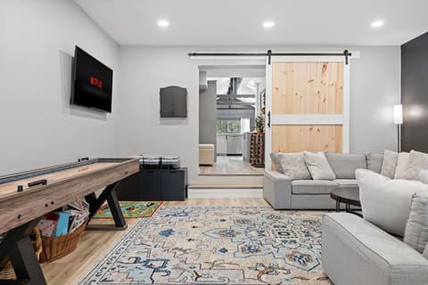 Ultimate Entertainment Lounge
A spacious and modern lounge area featuring a cozy sectional, a big-screen TV, and stylish barn doors. The perfect spot to kick back and enjoy movies, games, or just good company.
