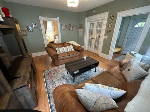 Living room with two squashy couches and an entertainment center