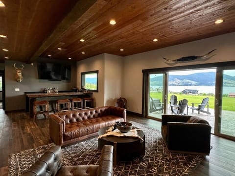 The downstairs den is your spot to unwind - complete with a wood burning fireplace and a four-stool bar with prep sink and cooler.