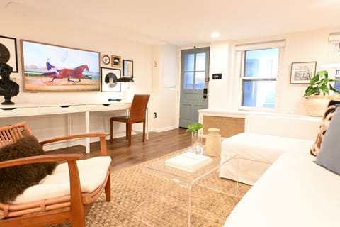 Bright living room with pull-out sofa, cozy lounge chair & 55" smart canvas TV.