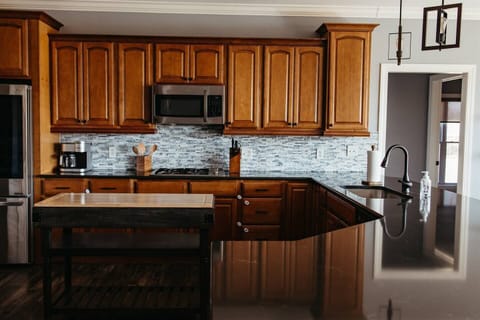 Kitchen with wooden cabinets and stainless steel appliances.
