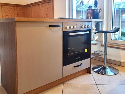 Cabinetry, Kitchen Appliance, Countertop, Wood, Kitchen, Home Appliance, Kitchen Stove, Major Appliance, Floor, Flooring