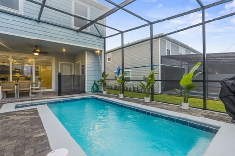 A sleek, refreshing pool designed for relaxation, featuring clear water, cozy seating, and a bright outdoor atmosphere.