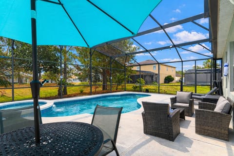 Private screened-in pool & spa oasis — crystal-clear water, sun-soaked lounging, and seamless indoor-outdoor living. Your own Florida escape, just minutes from the parks.
