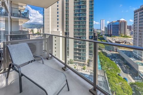Private lanai with stunning city and partial ocean views, perfect for enjoying a morning coffee or sunset drink.