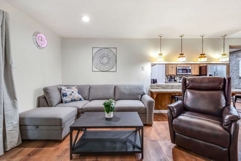 Relax and unwind in our cozy living room, complete with a comfortable sectional sofa, a plush recliner,