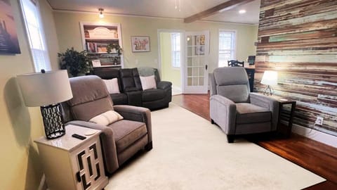 As you enter, a 120-year-old bead board wall greets you, with a recliner set