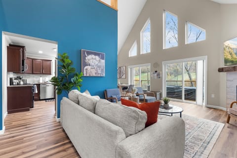 Spacious living room with vaulted ceilings, and a cozy fireplace