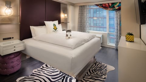 Unwind in a plush bed beneath warm, boutique lighting.