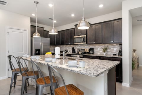 Fully-equipped kitchen with stainless steel appliances.