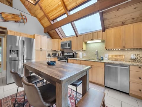 Spacious Kitchen has a Skylight Window, Granite Counters and Stainless Appliances