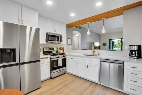 Step into a chef's paradise with this stylish, well-appointed modern kitchen. Featuring stainless steel appliances, sleek countertops, & ample cabinet space, it's the perfect space to cook & gather with family & friends, creating delicious memories!