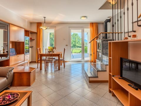 Flooring, Interior Design, Floor, Ceiling, Room, Furniture, Living Room, Television, Wood Stain, Chair