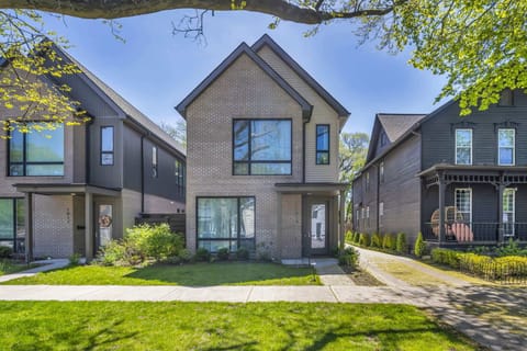 Welcome to your chic escape on Starkweather Ave in Cleveland’s vibrant heart—perfect for families or groups seeking comfort, style, and walkable fun. Shown here: a front view of our home and the shared driveway.