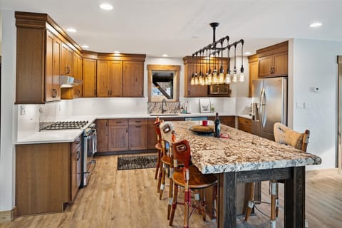 Cook in style with this fully equipped kitchen featuring rustic charm, a spacious island, and modern appliances to meet all your culinary needs.
