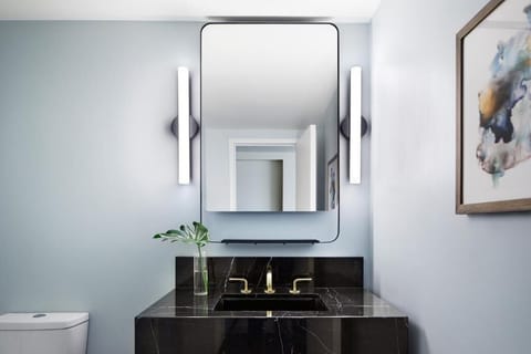 Refresh at a sleek vanity with bright, flattering lighting.