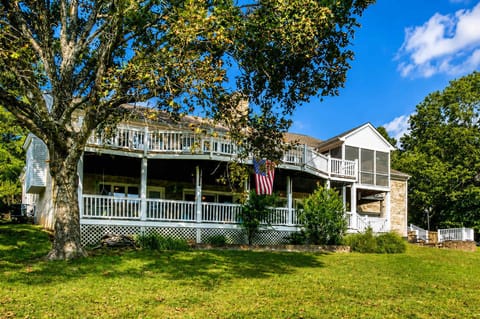 Relax on the back patio with natural green surroundings