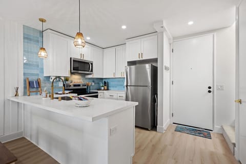 Beautiful updated kitchen featuring sleek stainless steel appliances with white cabinets
