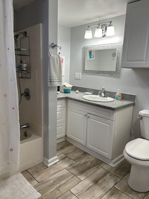 Full bathtub and shower with a safety