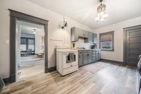- Spacious kitchen area with stove, ample counter space, and dining access   - Decorative lighting adds charm to this practical cooking zone   - Ideal for preparing meals while staying connected with the living area