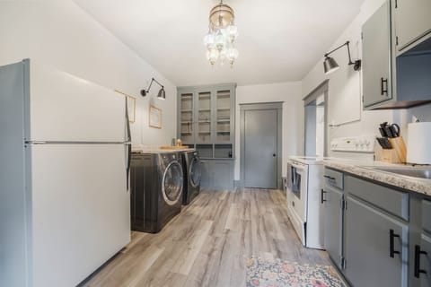 - Cook and clean easily in a fully equipped kitchen with modern appliances and washer-dryer   - Spacious layout offers ample counter space for meal prep convenience   - Perfect blend of function and style with soft gray cabinetry and wood floors