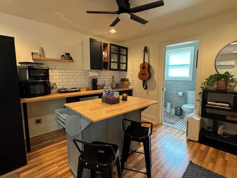 Island with seating and space to cook or work on laptop.