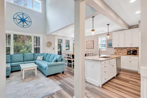 Unwind in the spacious family room, where the generous sectional invites you to sink in and relax. With a large TV as the focal point, this room is perfect for enjoying family game nights, watching sports, or simply catching up after a day in the sun